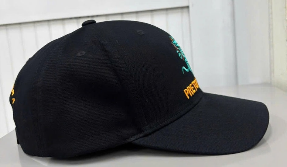 Pretow Mate™ from shecamp secure merchandise range features a Side profile view of the black baseball cap, highlighting its curved brim, structured front panels, stitched eyelets, and the side edge of the embroidered front Gecko logo and orange  branding.
