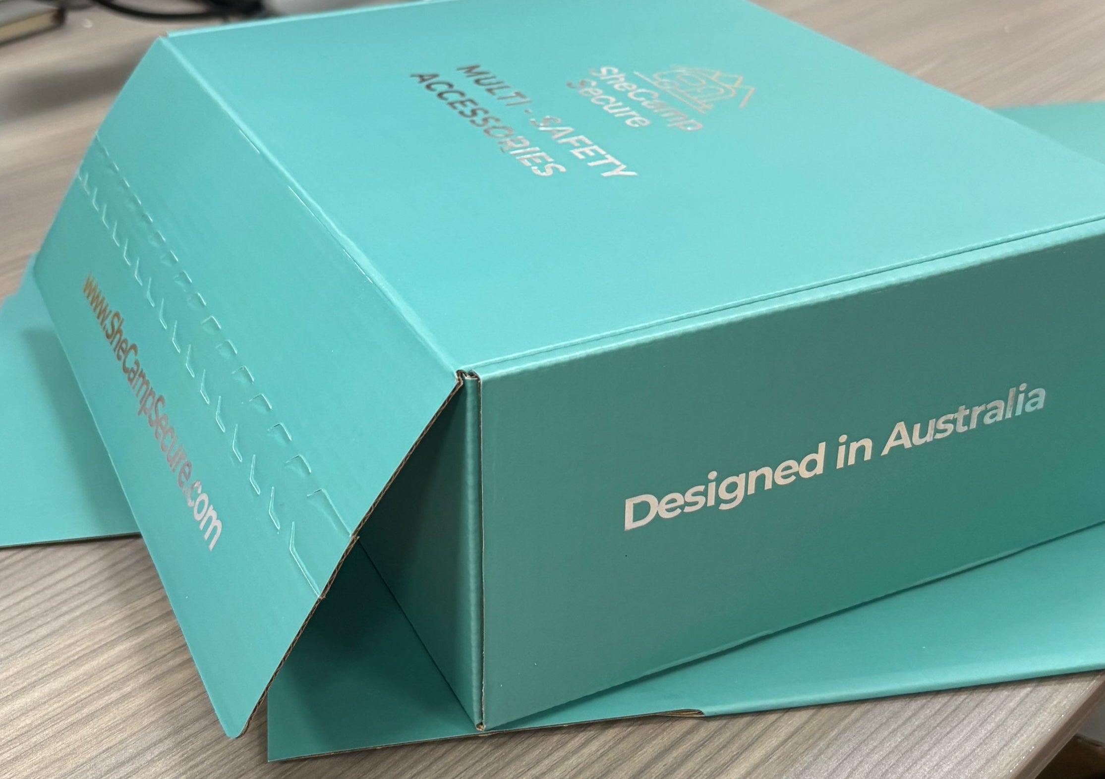 SheCamp Secure™ teal shipping mailer box for women’s safety accessories, designed in Australia